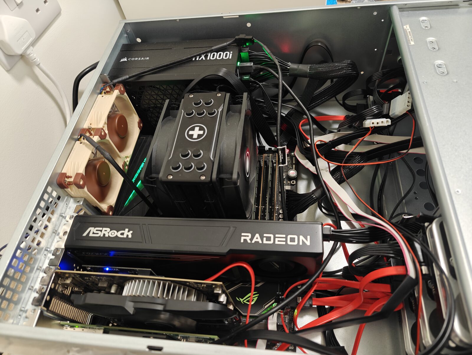 Inside the AI host: the ASRock Radeon AI PRO R9700, a large air cooler, and a Corsair HX1000i power supply